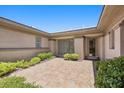 Private courtyard entrance featuring tiled flooring and lush green landscaping at 3048 Red Arrow Dr, Las Vegas, NV 89135