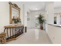 Bright foyer with glossy tile flooring, ornate table with mirror, and decorative plant at 3048 Red Arrow Dr, Las Vegas, NV 89135