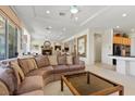 Open concept living room with fireplace, large windows, and view of the kitchen and dining area at 3048 Red Arrow Dr, Las Vegas, NV 89135