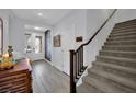 Bright entryway with stairs, stylish decor, and wood-look tile flooring at 333 Mandarin Hill Ln, Henderson, NV 89012