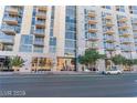 Modern apartment building featuring multiple balconies and expansive windows, with a well-kept street at 353 E Bonneville Ave # 711, Las Vegas, NV 89101
