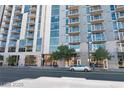 Exterior view of modern apartment building featuring large windows and balconies on a sunny day at 353 E Bonneville Ave # 711, Las Vegas, NV 89101