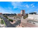 Panoramic city view features blue skies, palm trees and various buildings near a street intersection at 353 E Bonneville Ave # 711, Las Vegas, NV 89101