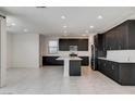Full view of the open kitchen with dark wood cabinets, white countertops, and recessed lighting at 532 Monarch Ridge Ct, North Las Vegas, NV 89084