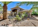 Gorgeous single-story home featuring a private courtyard and covered entryway with lush desert landscaping at 536 Pima Canyon Ct, Las Vegas, NV 89144
