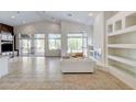 Bright living room featuring tile floors, high ceilings, and large windows with backyard views at 536 Pima Canyon Ct, Las Vegas, NV 89144