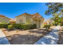 View of a quaint single-story home with low-maintenance landscaping on a sunny day at 5425 Comchec Way # 103, Las Vegas, NV 89108
