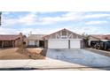 Charming single-story home with a two-car garage, desert landscaping, and a red-tiled roof at 5570 Palm St, Las Vegas, NV 89120