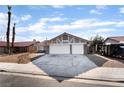 Charming single-story home with a two-car garage, desert landscaping, and a red-tiled roof at 5570 Palm St, Las Vegas, NV 89120