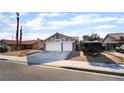 Charming single-story home with a two-car garage, desert landscaping, and a red-tiled roof at 5570 Palm St, Las Vegas, NV 89120