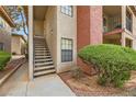 Close-up of condo exterior, featuring well-maintained landscaping, stairs, and building details at 5576 W Rochelle Ave # 27C, Las Vegas, NV 89103