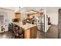 Bright kitchen featuring granite countertops, wood cabinets and stainless steel appliances at 5754 Cinnabar Ave, Las Vegas, NV 89110