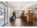 An open-concept kitchen with stainless steel appliances and a breakfast bar at 5754 Cinnabar Ave, Las Vegas, NV 89110