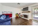 Cozy living room features a fireplace and sliding doors to the backyard at 5754 Cinnabar Ave, Las Vegas, NV 89110