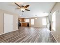 This open living area has great natural light with kitchen access and modern ceiling fan at 7216 Liberty Pride St, Las Vegas, NV 89148