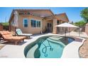 Backyard pool with lounge chairs and umbrella, perfect for relaxing and entertaining outdoors at 7252 Blowing Breeze Ave, Las Vegas, NV 89179