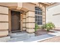 A home's front door is framed by decorative pillars and well-maintained landscaping at 8737 Autumn Valley Ave, Las Vegas, NV 89129