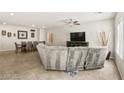 Bright living room with tile floors and a ceiling fan, open to a dining area at 8937 Pelican Point St, Las Vegas, NV 89178