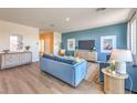 Open living room showcasing blue accent wall, modern decor, and wood flooring at 1194 Dre Harbor Pl # Lot 87, North Las Vegas, NV 89084