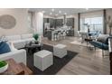Bright living room with contemporary furnishings, flowing into kitchen and dining areas at 1556 Pacific Baza St, Las Vegas, NV 89138