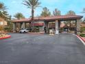 Community entrance gate featuring stone columns, tile roofing and security booth at 2200 S Fort Apache Rd # 1101, Las Vegas, NV 89117
