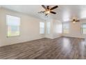 Bright living room featuring wood flooring, modern ceiling fans and large windows at 2400 Dutchmans Pipe Ct, Las Vegas, NV 89106