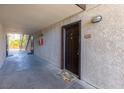Hallway to unit 1116 with a brown entry door and welcome mat at 2451 N Rainbow Blvd # 1116, Las Vegas, NV 89108