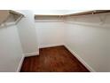 Walk-in closet providing ample storage with built-in shelving and dark hardwood floors for organized elegance at 3930 Starfield Ln, Las Vegas, NV 89147