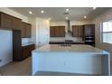 A spacious kitchen with a large center island, granite countertops, and stainless steel appliances at 560 Preston Oak Pl, Las Vegas, NV 89138