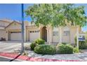 Single-story home with a three-car garage, xeriscaping, and covered front porch at 5929 Caddy Ridge St, North Las Vegas, NV 89031