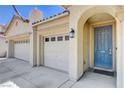 A cozy home with a convenient three-car garage and an inviting, arched entryway at 5929 Caddy Ridge St, North Las Vegas, NV 89031