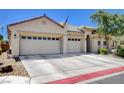 A charming single-story house featuring a three-car garage and well-kept landscaping at 5929 Caddy Ridge St, North Las Vegas, NV 89031