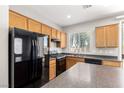 Efficient kitchen with sleek black appliances and durable countertops at 6548 Butterfly Sky St, North Las Vegas, NV 89084
