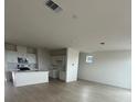 Bright, open-concept kitchen featuring white cabinets, stainless steel appliances, and hardwood floors at 6604 Bowery St, Las Vegas, NV 89148