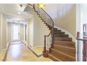 Grand entryway featuring a curved staircase, tiled floor, and elegant lighting at 7057 Fort Union Ct, Las Vegas, NV 89179