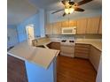 Modern kitchen with bright countertops, wood cabinets, and modern appliances at 7905 Ryandale Cir # 201, Las Vegas, NV 89145