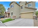 Front elevation of a two-story home featuring a two-car garage, stone accents, and manicured lawn at 8335 Martinborough Ave, Las Vegas, NV 89131