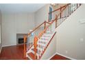 Bright living room boasts wood floors, fireplace, and a staircase leading to the upper level at 860 Bergamont Dr, Henderson, NV 89002