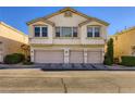 Exterior of a three-story townhouse featuring a three-car garage at 8842 Duncan Barrel Ave # 103, Las Vegas, NV 89178