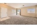 Spacious living room with neutral walls, carpet, and natural light at 8842 Duncan Barrel Ave # 103, Las Vegas, NV 89178