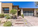 View of modern home entrance with decorative stones and desert landscaping at 975 Amara Way, Henderson, NV 89052