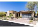Contemporary house with minimalist landscaping and a modern garage door at 975 Amara Way, Henderson, NV 89052