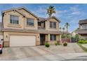 Charming two-story home featuring a well-manicured lawn, mature trees, and desert landscaping at 108 Parker Ranch Dr, Henderson, NV 89012