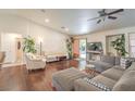 Bright living room with hardwood floors, neutral furniture, and sliding glass doors to the backyard at 161 Swale Ln, Las Vegas, NV 89144