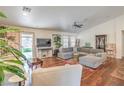 Spacious living room with hardwood floors, neutral color palette, ample seating, and sliding glass door at 161 Swale Ln, Las Vegas, NV 89144
