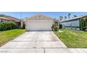 Single-story home featuring a two car garage and neatly maintained lawn with a classic suburban design at 1949 King Hill St, Las Vegas, NV 89106