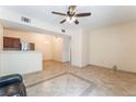 Bright living area with open layout, stylish tile floor, and kitchen access with stainless appliances at 2141 Hussium Hills St # 108, Las Vegas, NV 89108