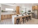 Bright kitchen featuring an expansive island with seating and modern finishes, stainless steel refrigerator at 2561 Terrytown Ave, Henderson, NV 89052