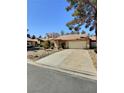 Charming single-story home with a two-car garage, desert landscaping, and a tile roof in a quiet neighborhood at 3619 Edinburgh Dr, Las Vegas, NV 89103