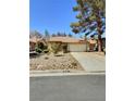Charming single-story home with a two-car garage, desert landscaping, and a tile roof in a quiet neighborhood at 3619 Edinburgh Dr, Las Vegas, NV 89103